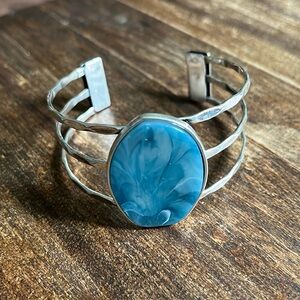 Silver tone cuff bracelet with blue stone